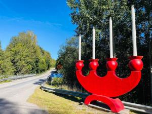 a red vase with candles in it on the side of a road at 4 person holiday home in HALLABRO-By Traum in Hallabro