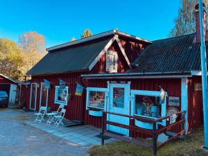a red building with a sign in front of it at 4 person holiday home in HALLABRO-By Traum in Hallabro