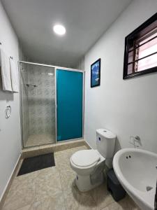 a bathroom with a toilet and a sink and a shower at Family house colonial-style in Cartagena de Indias