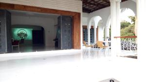 a view of a porch with a table and chairs at Egg Botanical View in Entebbe
