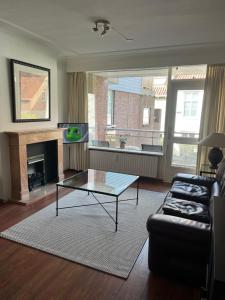 a living room with a couch and a coffee table at Franciscus in Bergen op Zoom