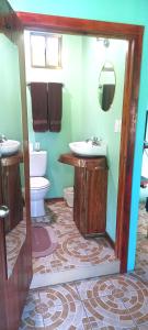 a bathroom with a sink and a toilet at Hospedaje Rosa Del Mar & Sweets Cafe in Big Corn Island