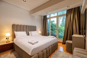 a bedroom with a large bed and a window at Luxury Family Villa with Private Pool in Sheikh Zayed Khan in 6th Of October +93 photos