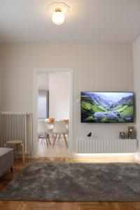 a living room with a flat screen tv on a wall at Florina four seasons apartment in Florina
