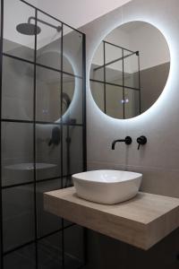 a bathroom with a sink and a mirror at Florina four seasons apartment in Florina