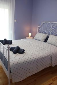 a blue bedroom with a white bed with pillows on it at Florina four seasons apartment in Florina