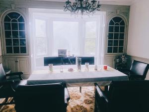 a dining room with a table and chairs and a chandelier at Lin Wood Retreat in Plainfield