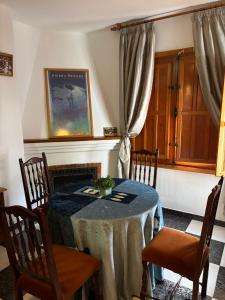 a dining room with a table and chairs at Mulhacen Apartment in Trevélez +9 photos