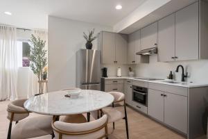 a kitchen with a table and chairs in a kitchen at Luxurious Gem Near Zion & Sand Hollow in Hurricane +17 photos
