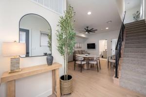 a living room with a staircase and a dining room at Luxurious Gem Near Zion & Sand Hollow in Hurricane
