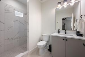 a white bathroom with a toilet and a sink at Luxurious Gem Near Zion & Sand Hollow in Hurricane