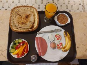 a tray of food with a plate of food and a drink at Cairo Nomads Hostel in Cairo +23 photos