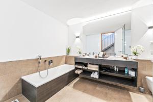 a bathroom with a tub and a sink at Penthouse Panorama Deluxe - Seesicht - BBQ - Beach Paradise - Loft Premium in Öhningen +39 photos