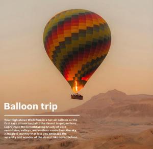 a hot air balloon flying over the desert at Bedouin Camp&tour in Wadi Rum