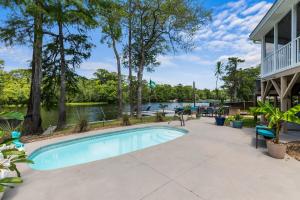 a swimming pool in front of a house at Pirate's Cove Bungalow in Conway