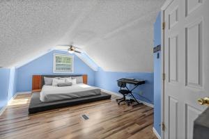 a bedroom with blue walls and a bed and a piano at Pirate's Cove Bungalow in Conway +25 photos