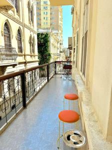 a red stool sitting on the side of a balcony at Camden Hostel in Baku