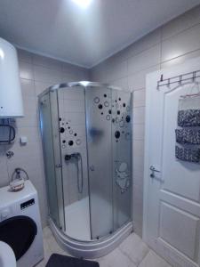 a shower with a glass door in a bathroom at Studio - Bee Happy in Sarajevo +24 photos