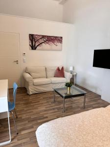 a living room with a couch and a table at B@Home Apartments in Sanem