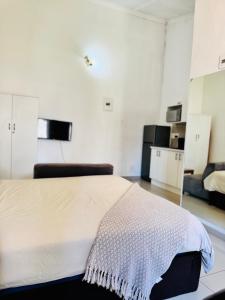 a bedroom with a bed in a room at Airport Guest House in Kempton Park +10 photos
