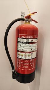 a fire extinguisher is attached to a wall at النبلا الفضي in Al Madinah