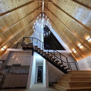 a staircase in a house with a chandelier at ES A frame in Gabala
