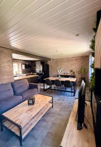 a living room with a couch and a table at Secret Factory & Spa in Soultz-Haut-Rhin +8 photos
