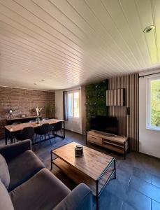 a living room with a couch and a table at Secret Factory & Spa in Soultz-Haut-Rhin