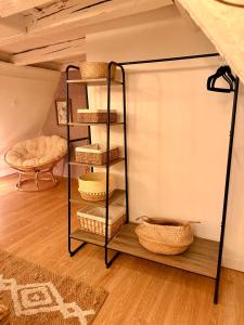 a shelf with baskets on it in a room at Secret Factory & Spa in Soultz-Haut-Rhin