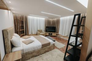 a bedroom with a large bed and a television at Hotel Kristal in Korçë