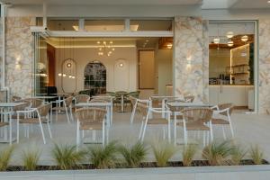 a restaurant with tables and chairs in front of a building at Swan Lake in Ioannina