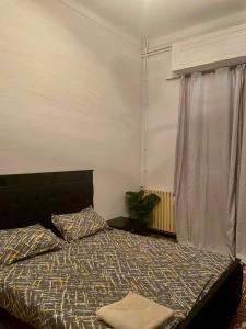 a bedroom with a bed and a window at Le soleil in Alger
