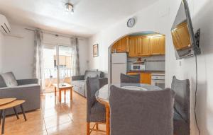 a kitchen and a living room with a table and chairs at Awesome Apartment In Torrevieja With Wifi in Torrevieja
