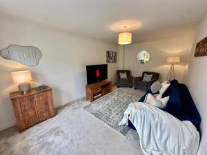 a living room with a couch and a tv at The Nest at Heaton Family Friendly Near Preston and Blackpool Ample Parking and WiFi in Kirkham