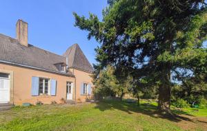 a house with a tree in front of it at Gite Avec Piscine in Parennes +20 photos