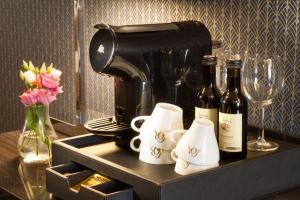 a coffee maker and two bottles of wine on a shelf at Hotel Mucha in Prague