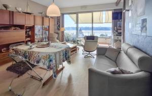 a living room with a couch and a table at Gorgeous Apartment In Dinard With House Sea View in Dinard