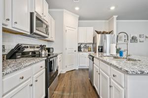 a kitchen with white cabinets and marble counter tops at 2059 Pinnacle Walk Drive Norcross in Norcross