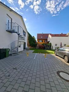 a driveway in front of a house with a car at Neue Moderne FeWo Europa-Park & Rulantica in Ringsheim