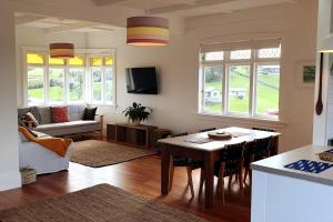 a living room with a table and a couch at The Cottage on the Olive Grove in Russell