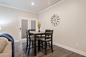 a dining room with a table and chairs and a clock at 2029 Pinnacle Walk Drive Norcross in Norcross