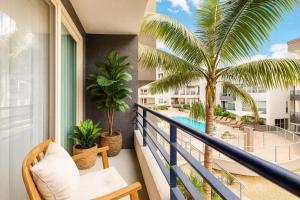 a balcony with a palm tree and a pool at Venice Sunny 2BR Haven - 7-min Walk to Venice Beach in Los Angeles