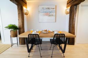 a dining room with a wooden table and chairs at Homely Rooms in Santander