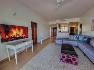 a living room with a couch and a fireplace at Spacious Penthouse with Stunning Beachfront Views 2 in Mombasa