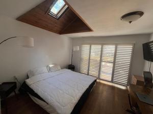 a bedroom with a large bed and a window at Sugar Suites Cozy Cabin Retreat Near Big Bear in Sugarloaf