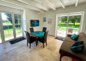 a living room with a table and a couch at Domaine des Anes - Gite des Mûriers 