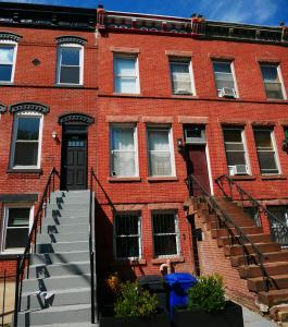 a red brick building with stairs in front of it at 10 Minute walk to Light Rail in Jersey City