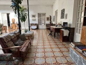 a living room with a couch and a table at Casa rosa 4 in Mercedes