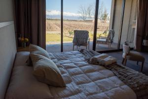 Ένα ή περισσότερα κρεβάτια σε δωμάτιο στο NOI Lodge Entre Viñedos