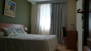 Łóżko lub łóżka w pokoju w obiekcie Hotel Montero